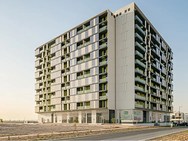 Full residential block with green balconies and podium