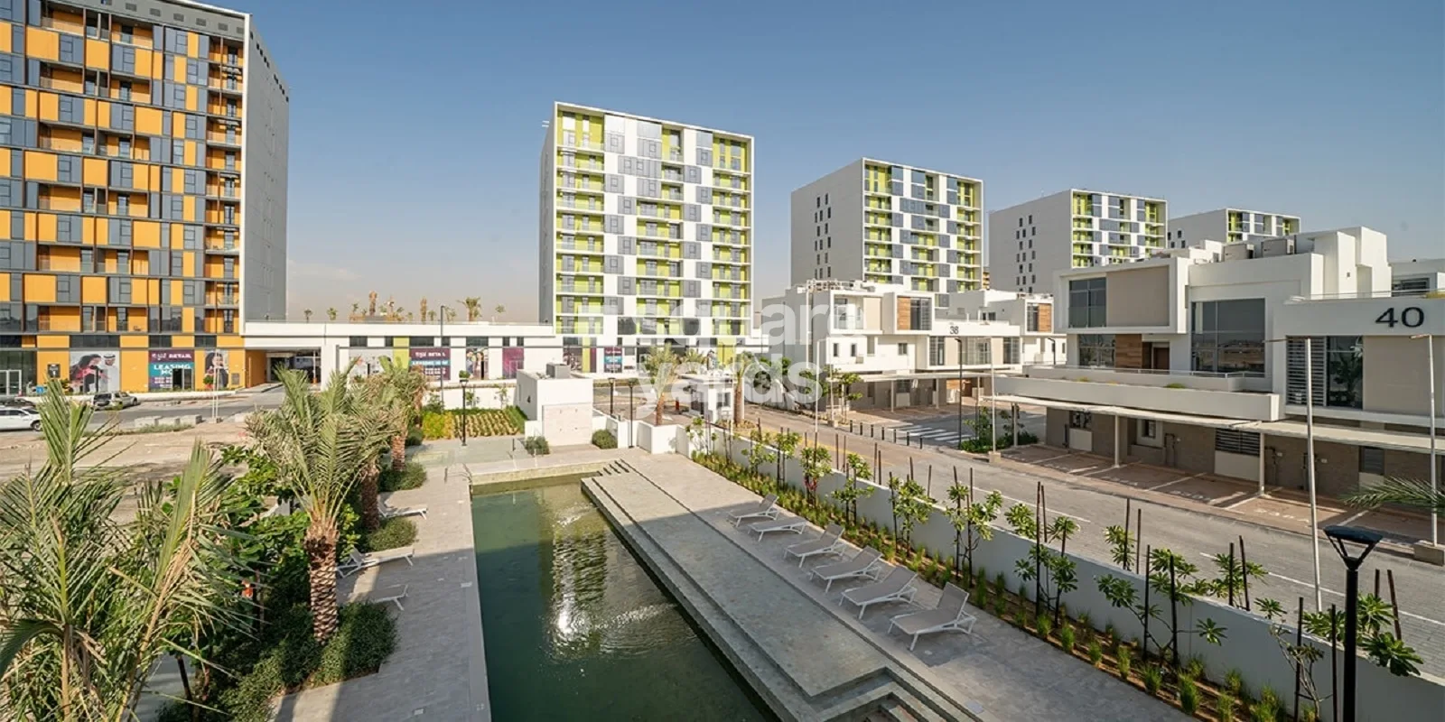 Water feature and loungers with Pulse towers behind