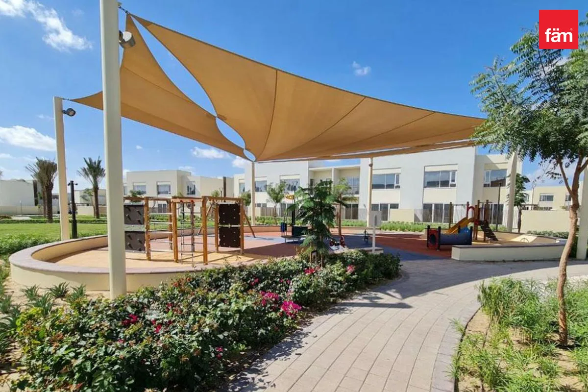 Playground with shade sails and Urbana townhouse blocks behind