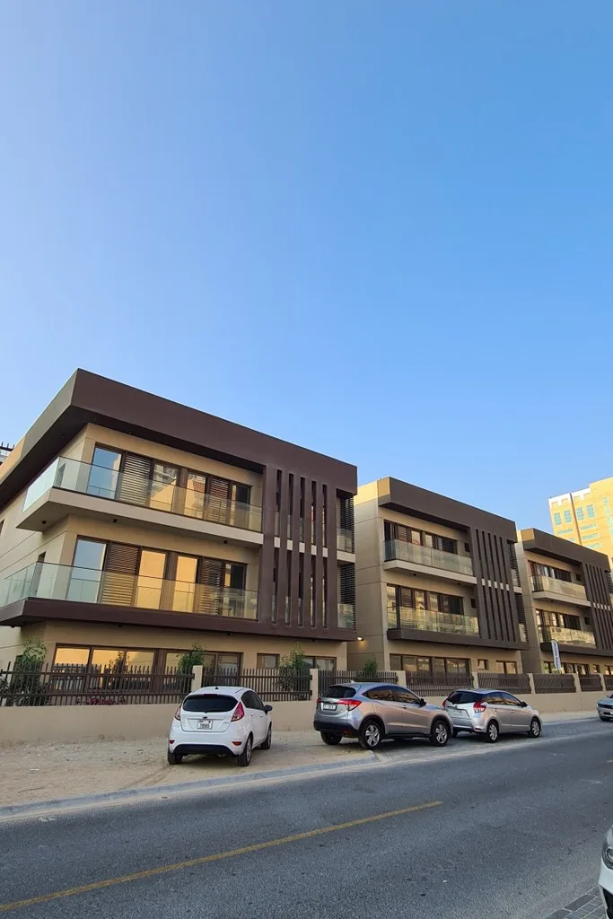 Three-storey brown and beige townhouse blocks from street