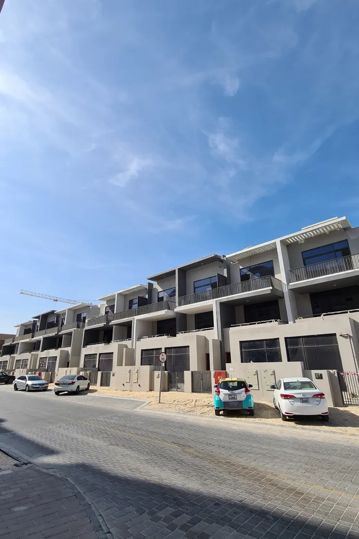 Row of grey townhouses along street