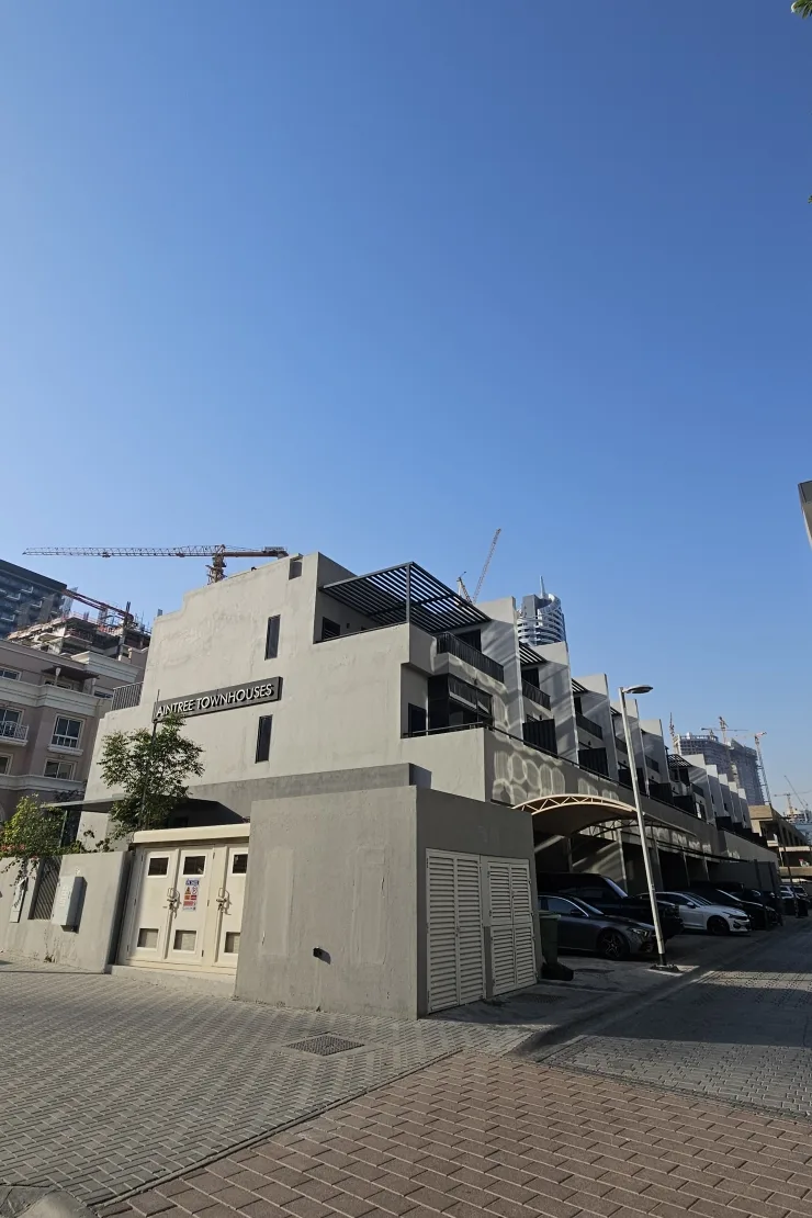 End of townhouse block with building signage