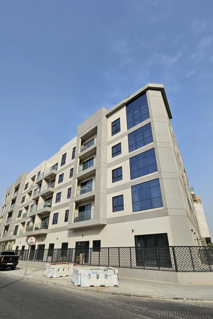 Full facade with glass balconies and patterned fence