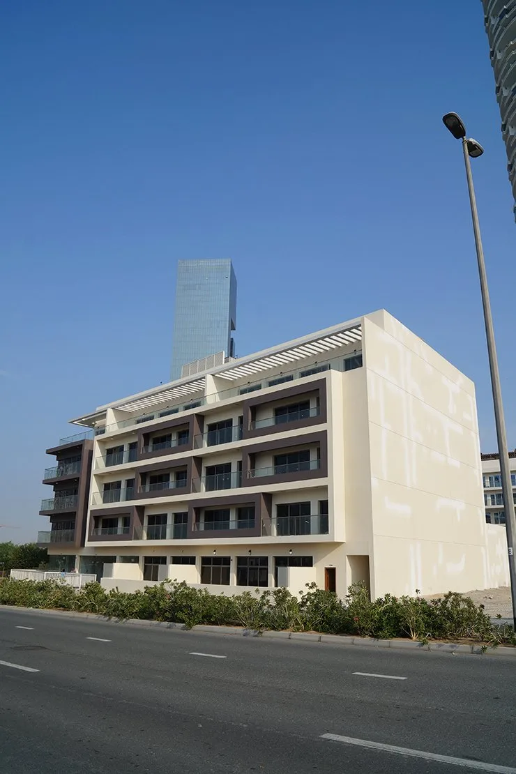Same building showing side facade and pergola roof