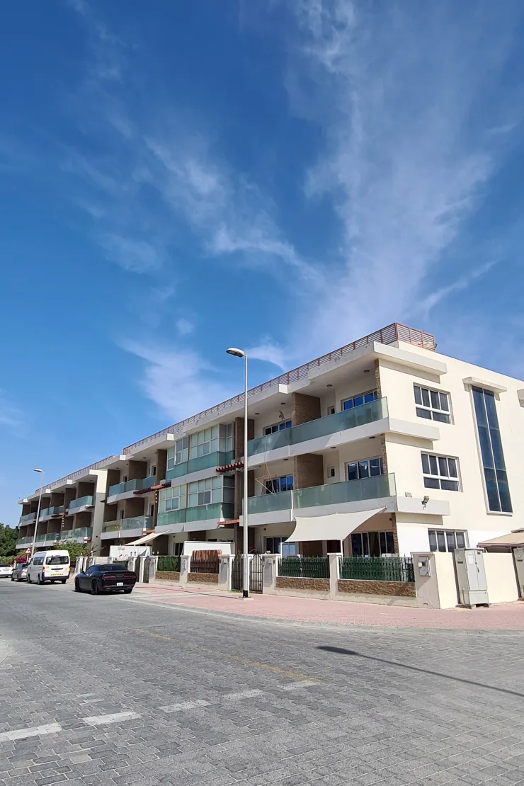 Three-storey block with glass balconies, street view