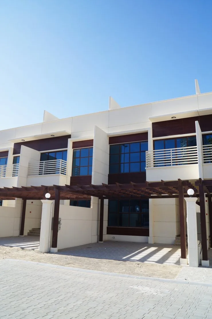 Two-storey townhouse facade with pergola and balconies