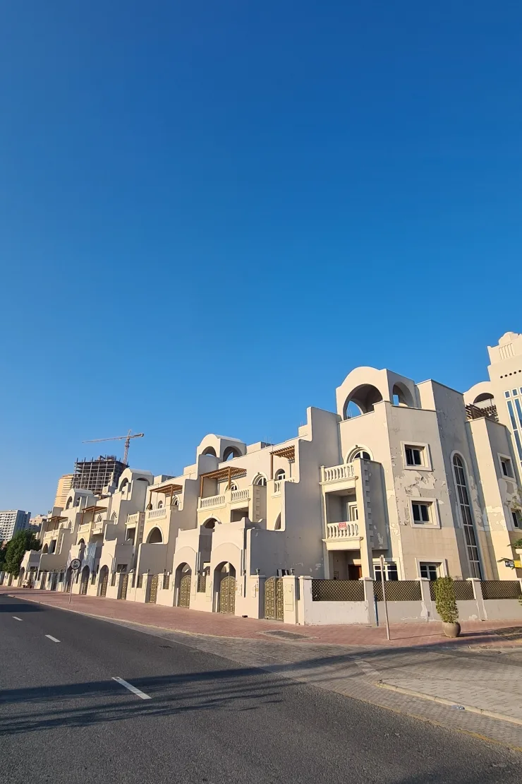 Row of arched townhouses along street