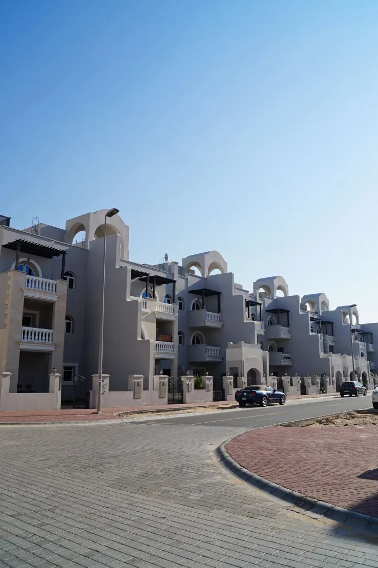 Stepped townhouse facades with arches and balconies
