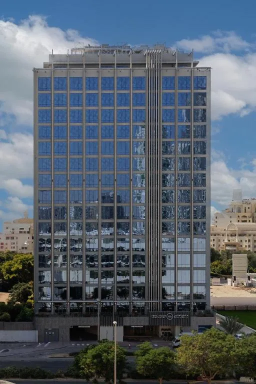 Full-height facade with vertical fin strip and entrance