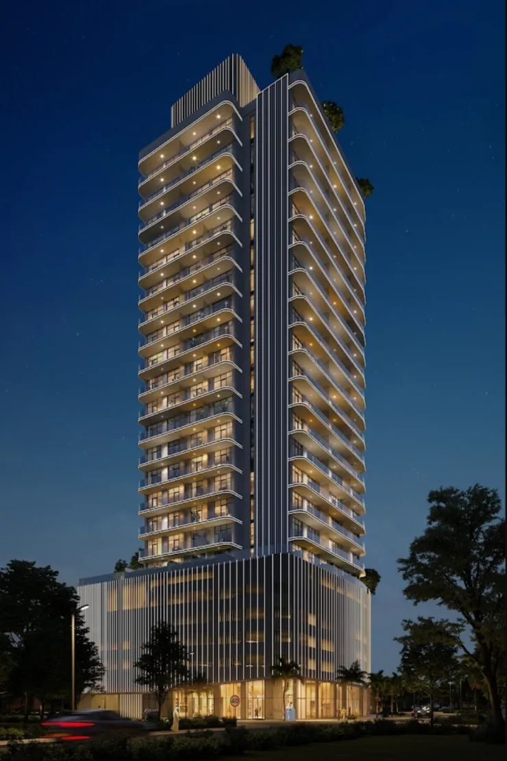 Night view of tower with lit balconies and podium