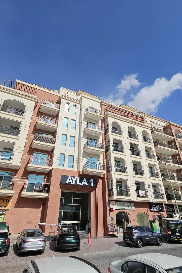 Ayla 1 facade with signage, street level