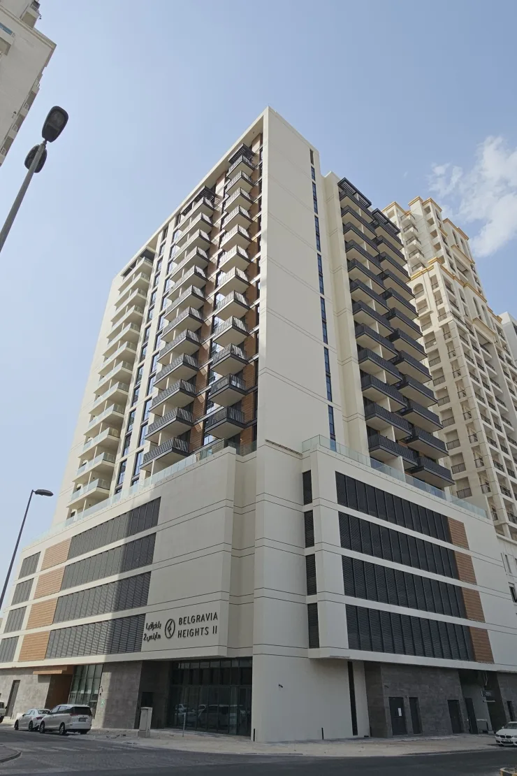 Cream tower with Belgravia Heights II signage on podium