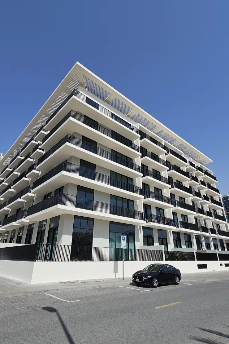 Completed corner facade with balconies and roof louvres