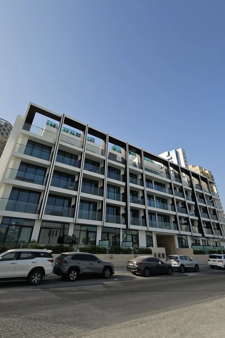 Street-side facade with dark frames and glass balconies