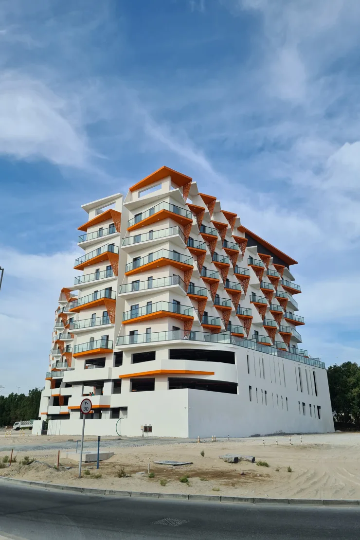 Corner view of stepped facade with orange canopies