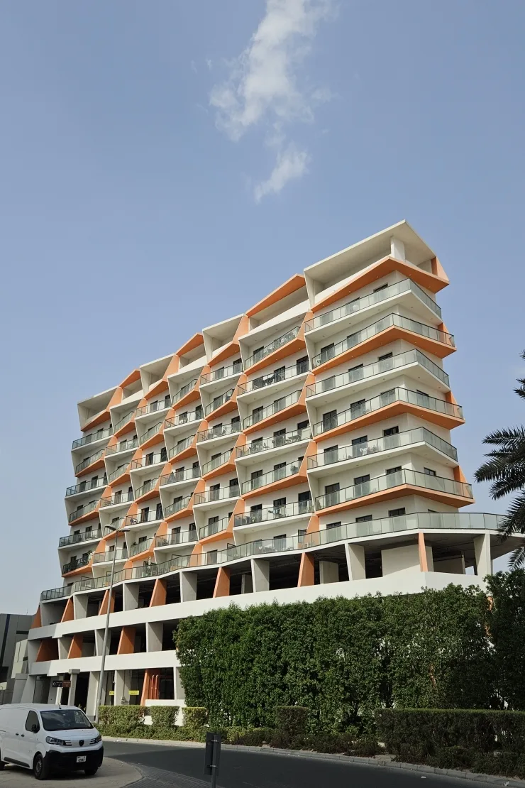 Full tower with zigzag orange balconies and podium