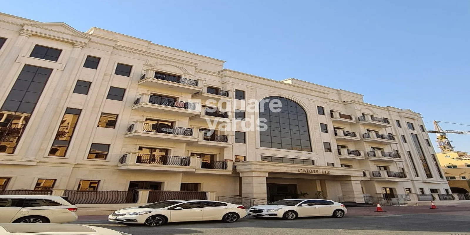 Cream classical facade with Cartel 112 signage and arched glazing