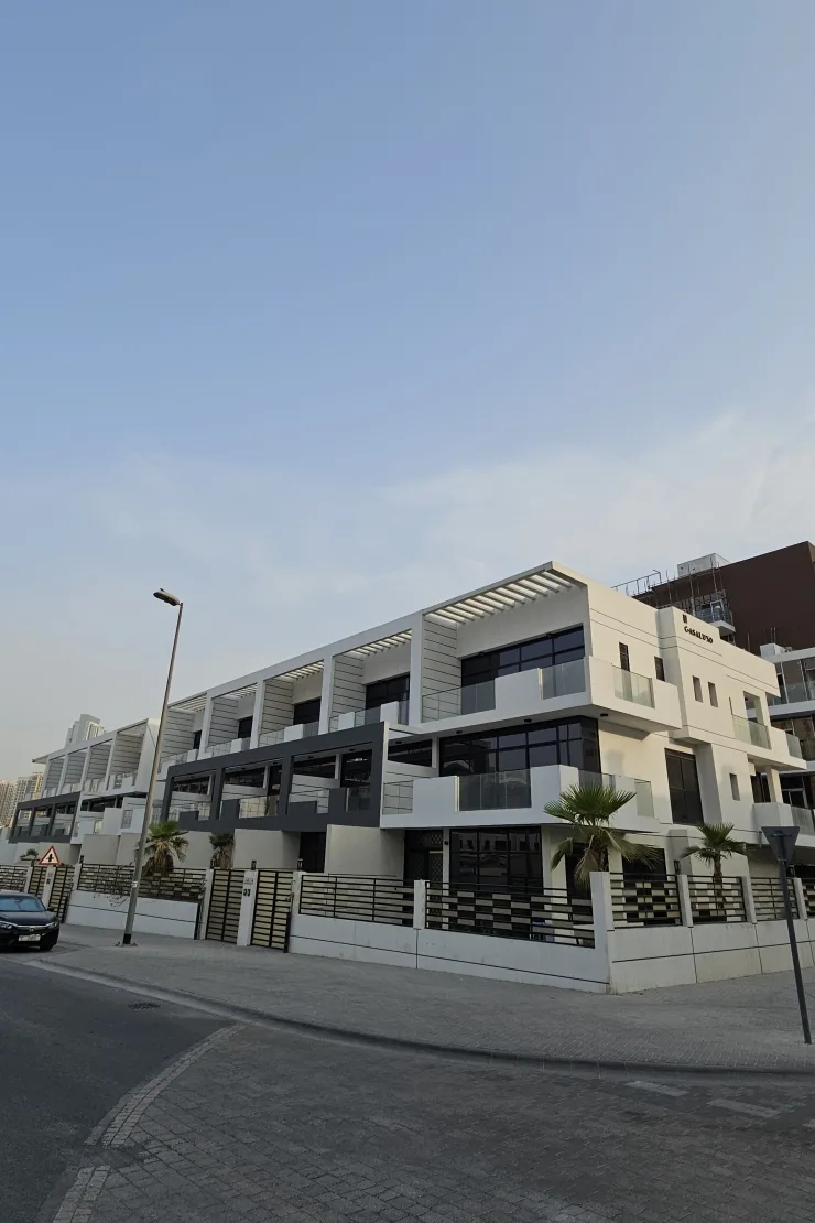 Corner of white townhouse block with Casa Luxo sign