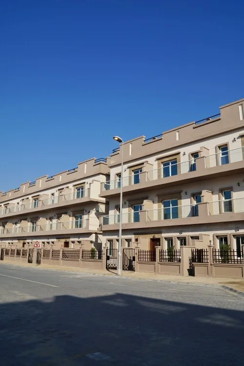 Row of low-rise blocks with crenellated parapets