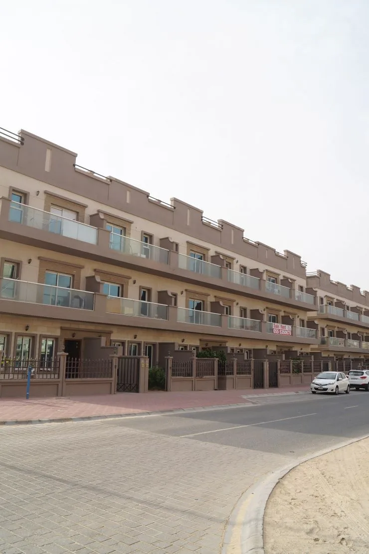 Long terraced facade with glass balconies along street