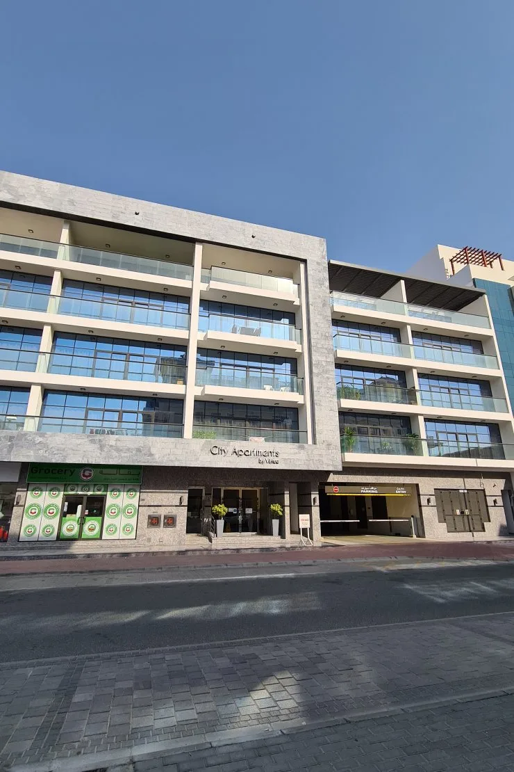 Front facade with City Apartments signage, ground to roof