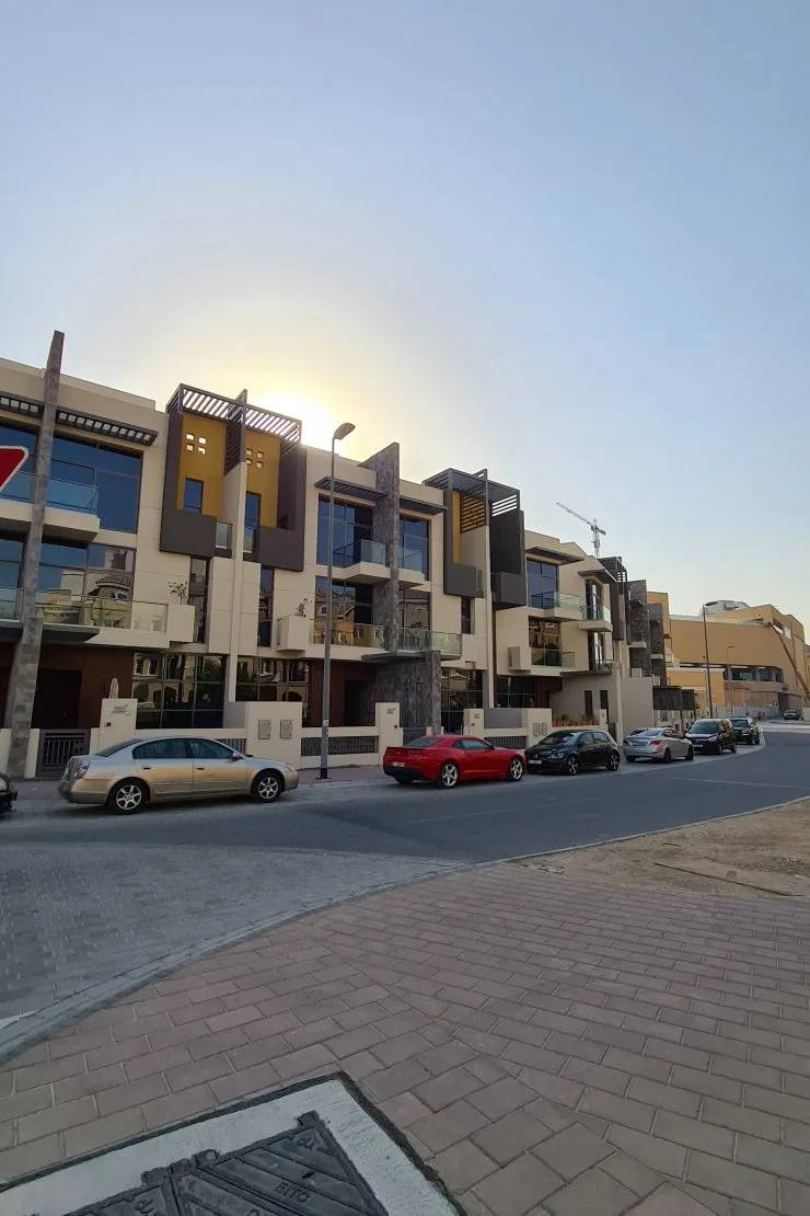 Townhouse facades with stone and yellow accents