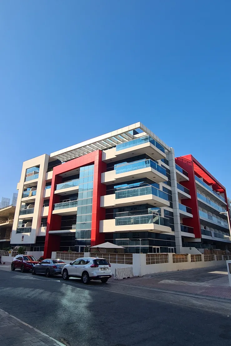 Corner view of completed building with red accents