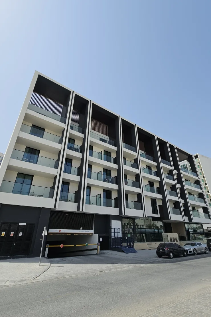 Completed six-storey facade with dark fins and balconies