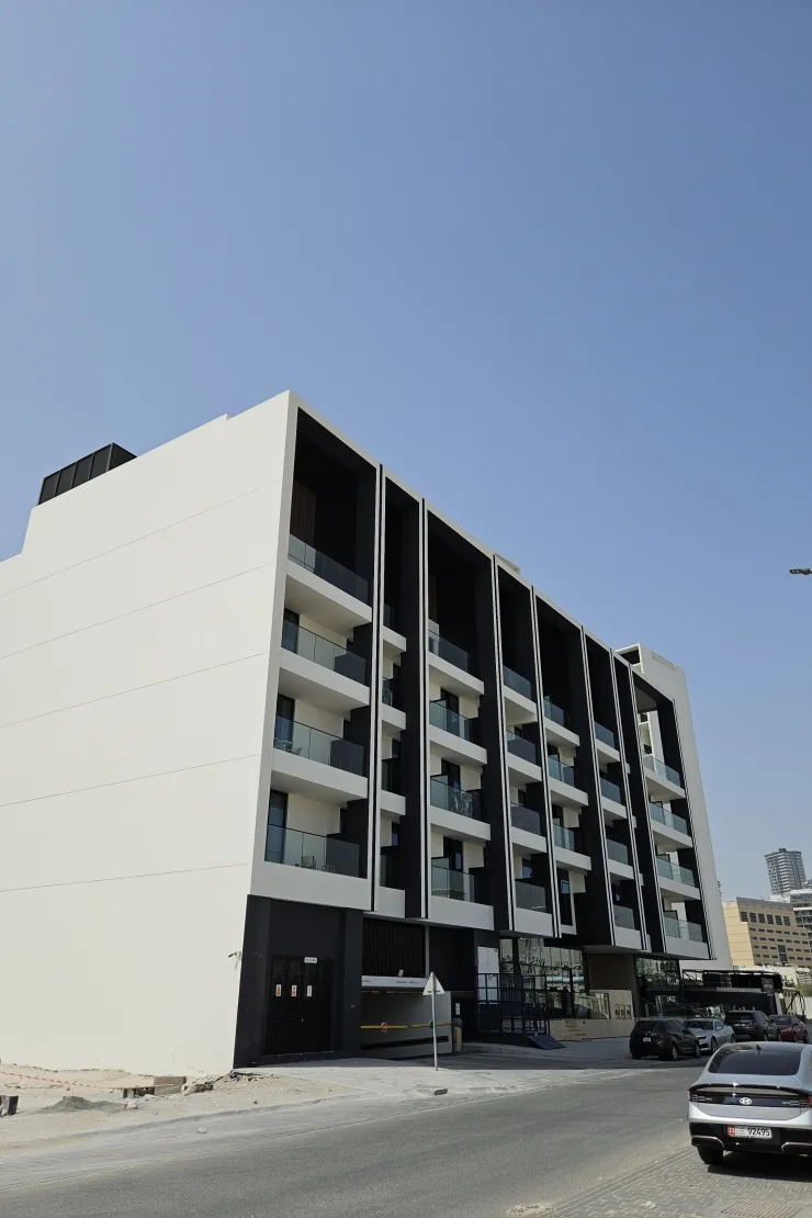 Corner view of completed building with white side wall