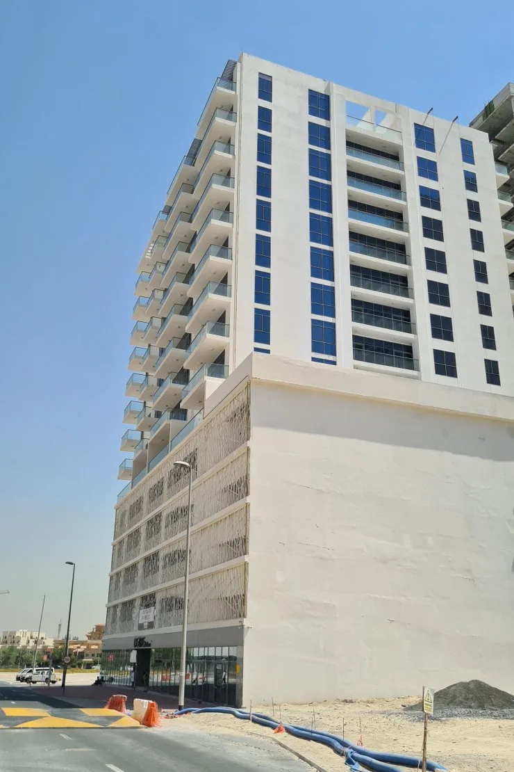 Corner view of white tower and patterned podium