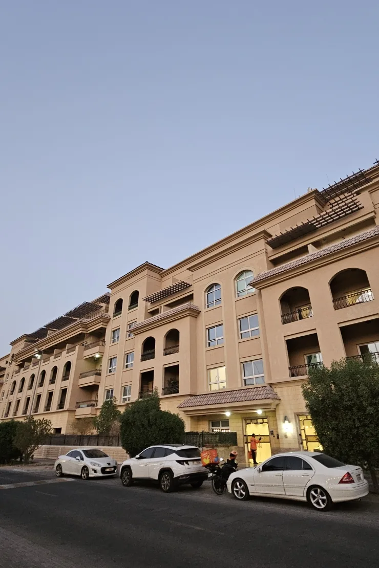 Facade with arched windows, balconies and entrance canopy