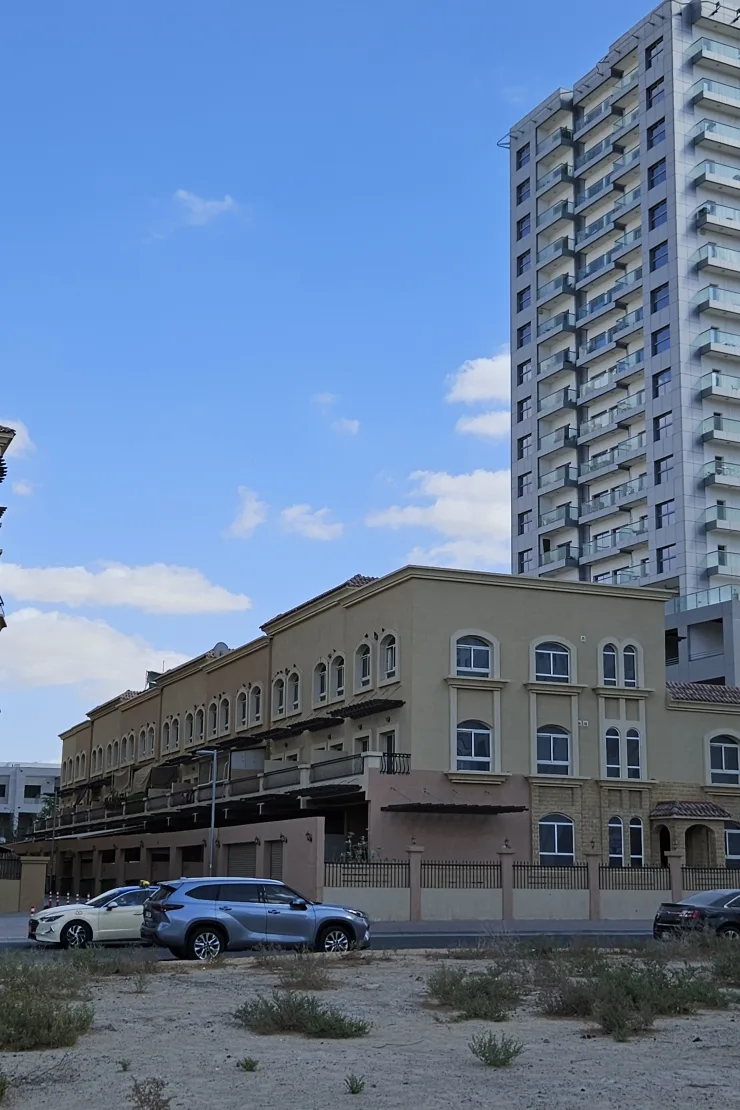 Low-rise Mediterranean villa block with arched windows
