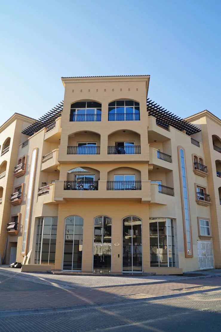 Corner facade with arched balconies and pergola roof