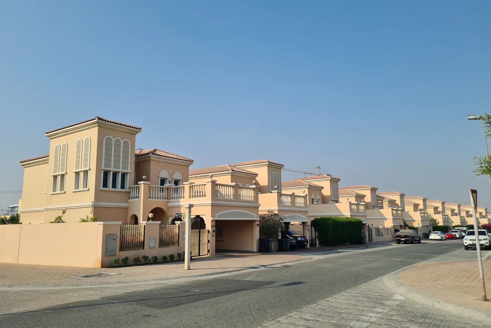 Row of peach Mediterranean-style villas on a street