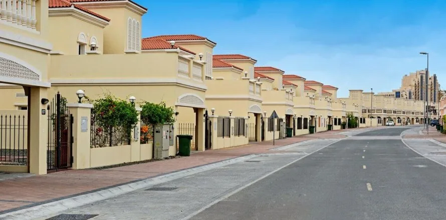 Terracotta-roofed villa row along a quiet street