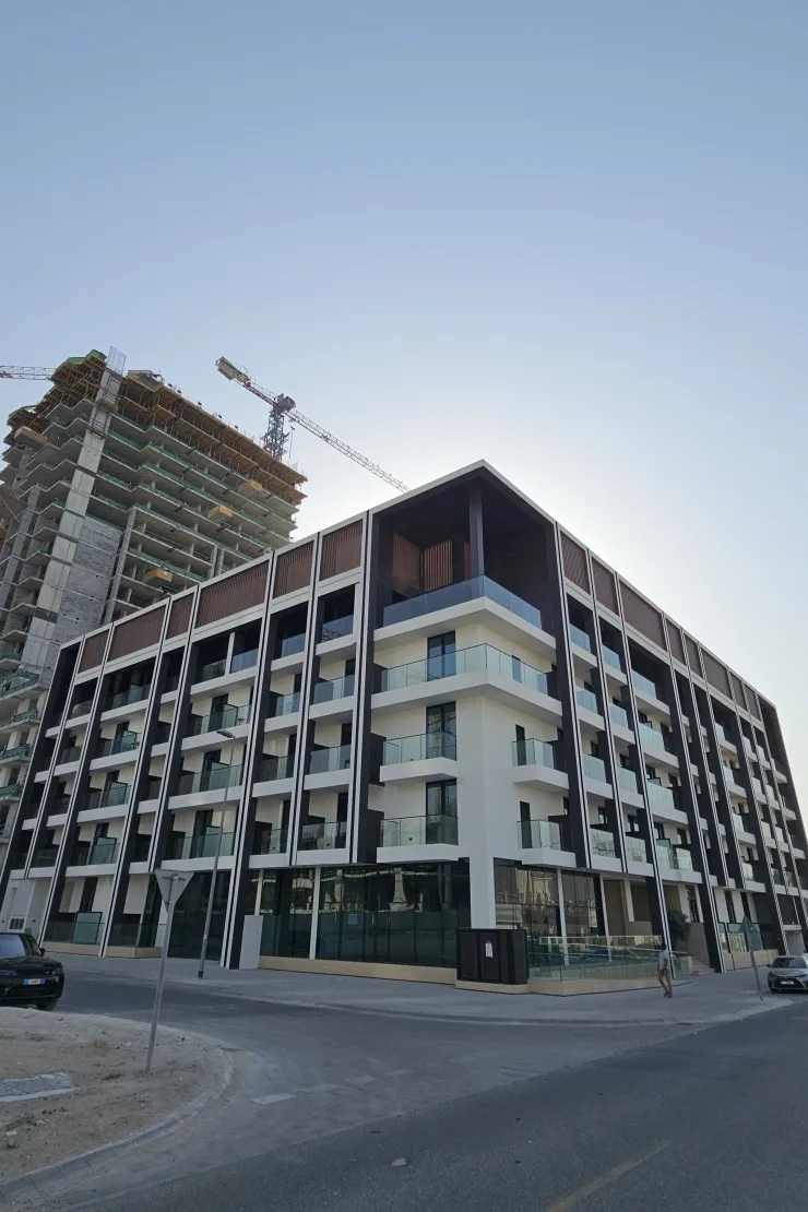 Completed low-rise with timber-slat crown and glass balconies
