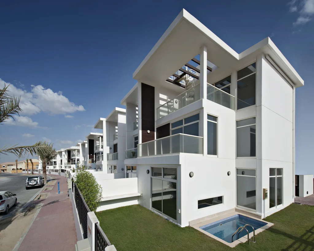White villa block with terraces and small pool
