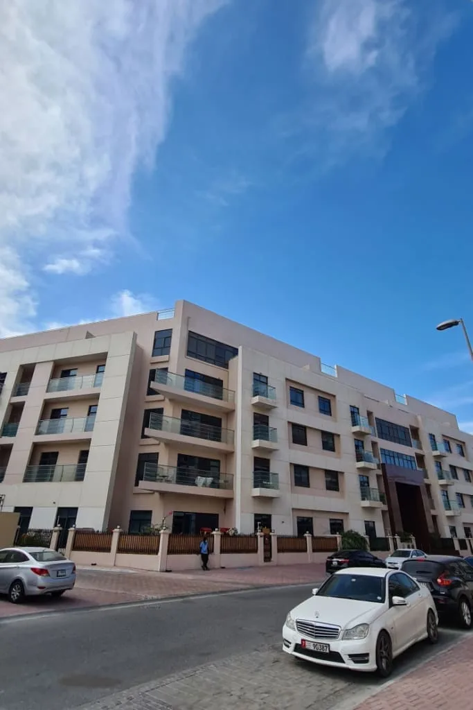 Five-storey beige building with brown entrance portal