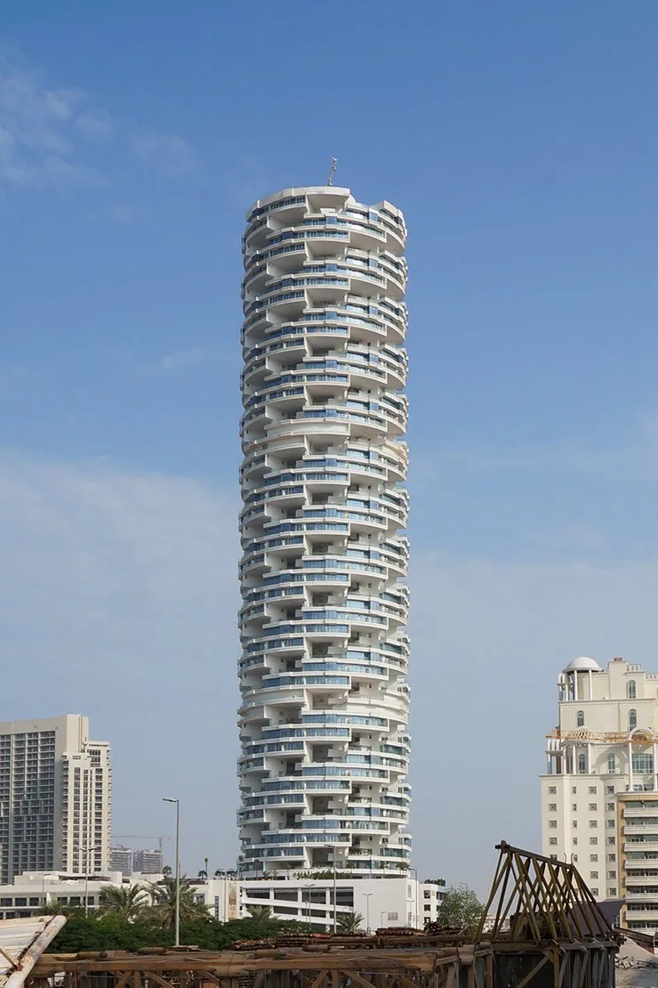 Full-height tower with stacked curved balconies