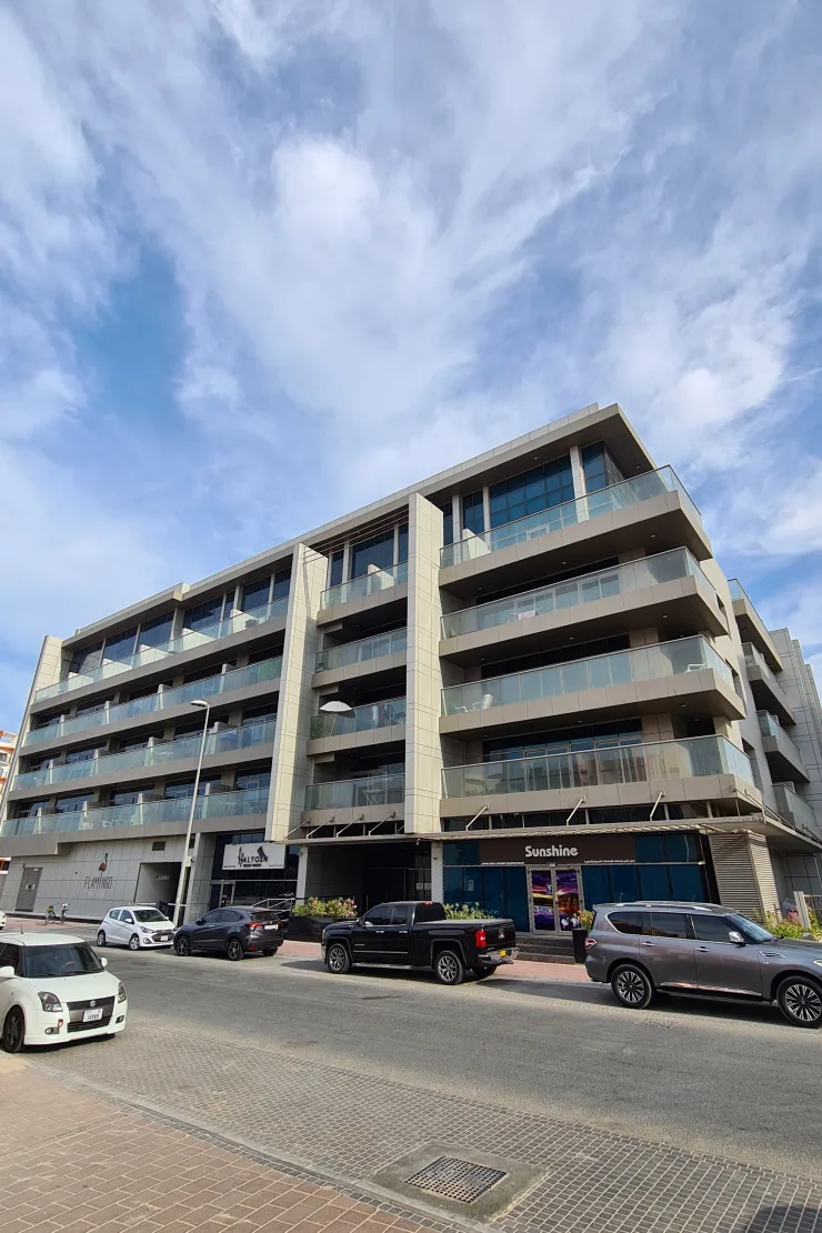 Corner view of balconies and ground-floor shops