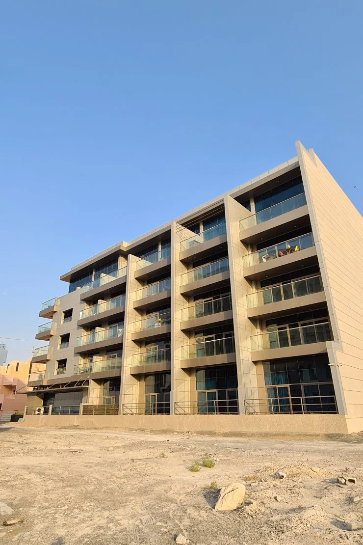 Side elevation with glass balconies and beige cladding