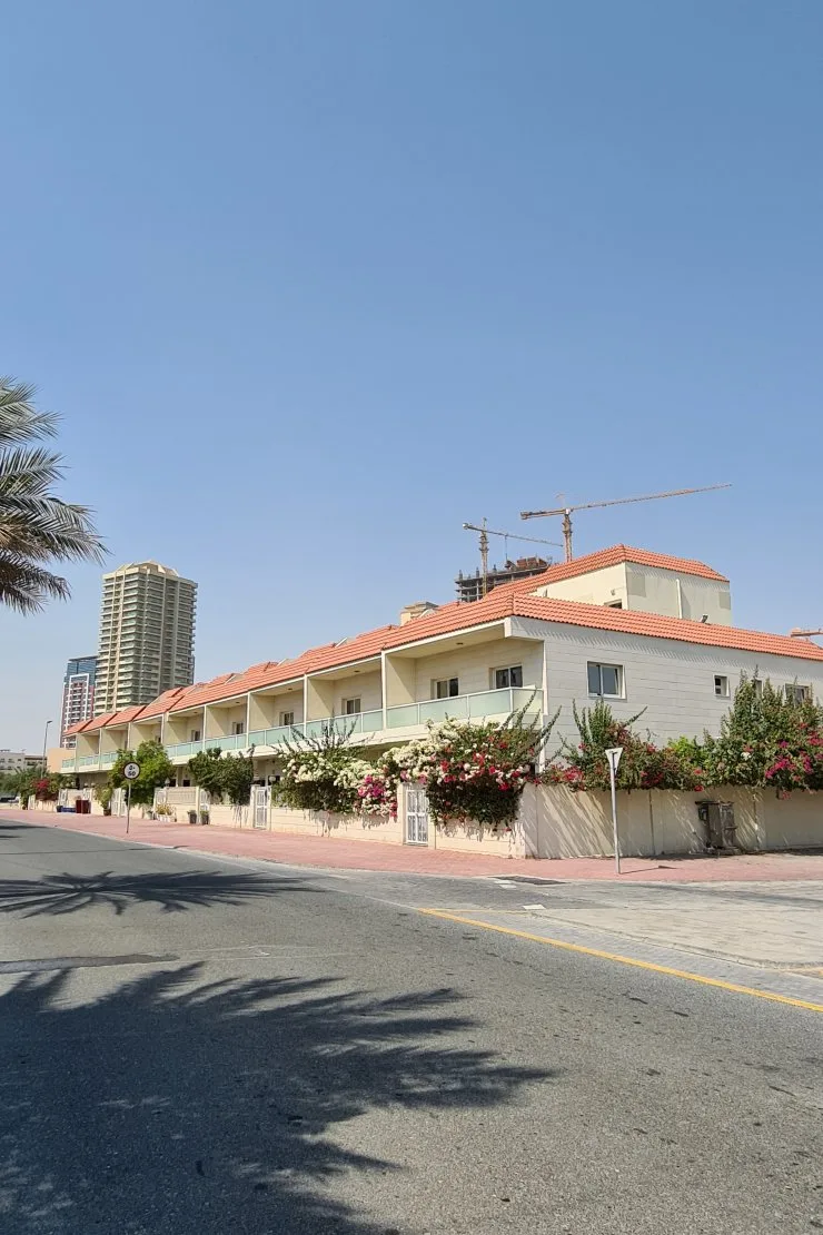 Villa row with bougainvillea along street