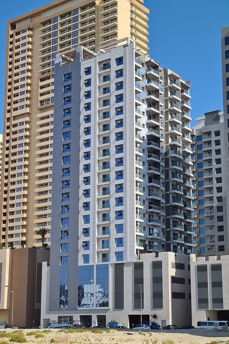 Tower facade and balconies beside beige neighbouring tower