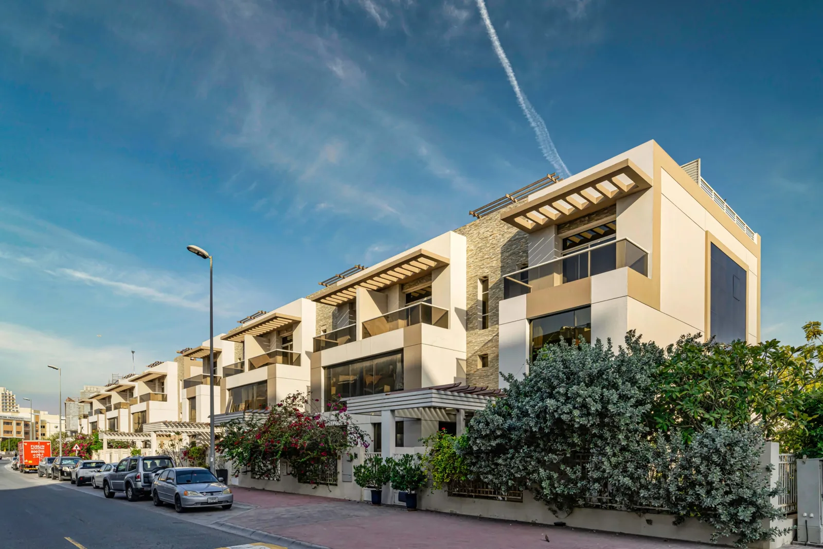 Row of villas with beige facade and pergolas