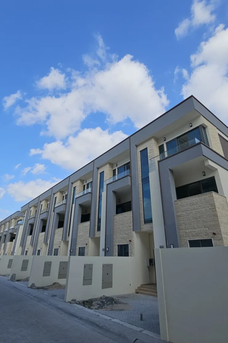 Townhouse row with stone cladding and balconies