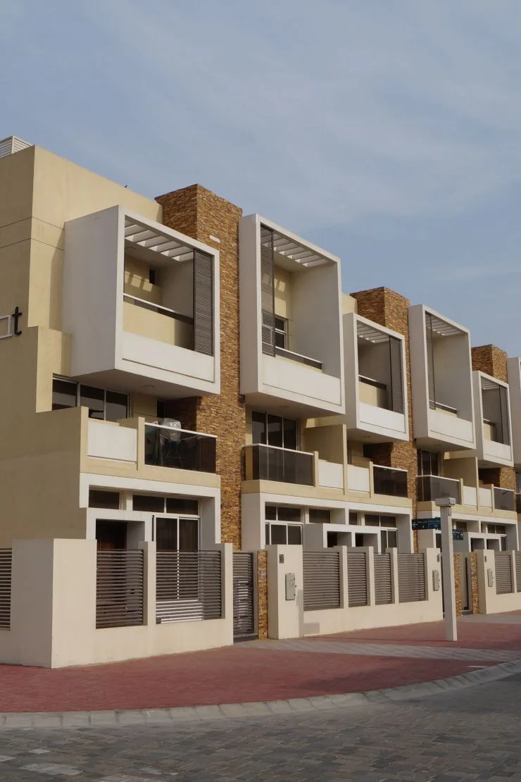 Row of townhouses with brick cladding and box balconies