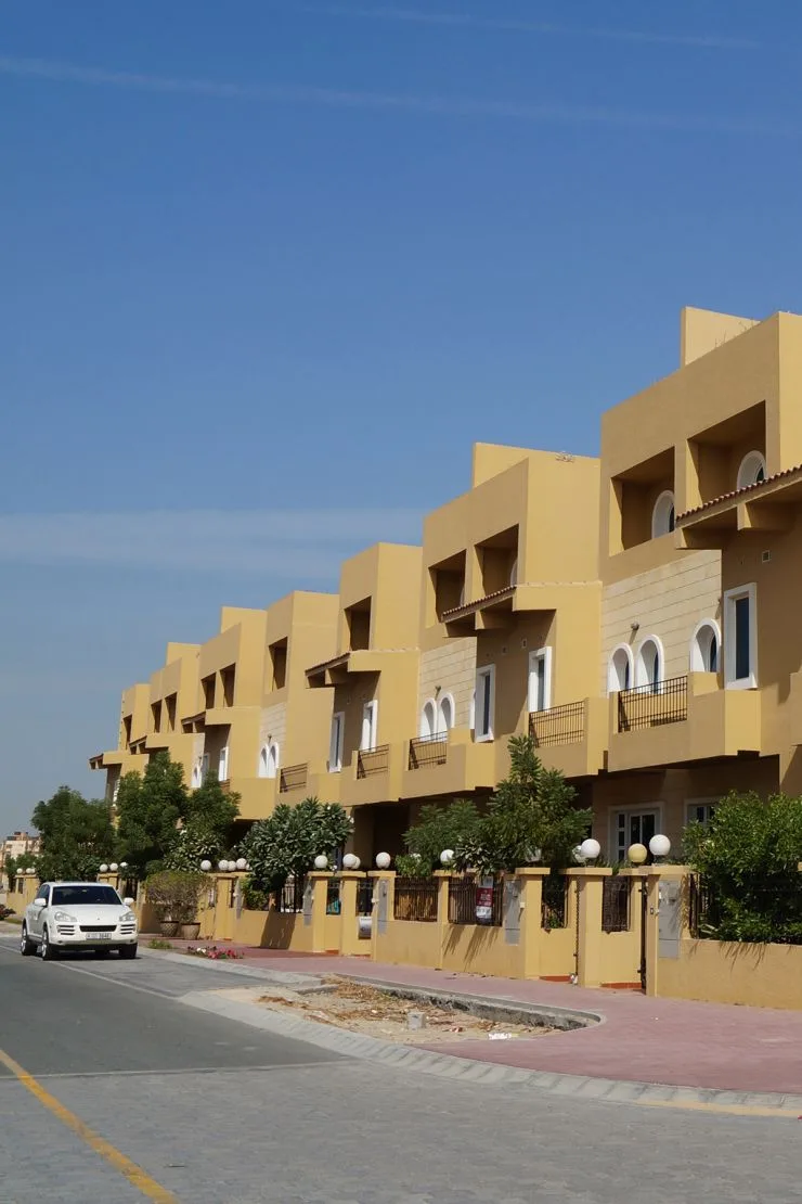 Row of ochre townhouse units along street