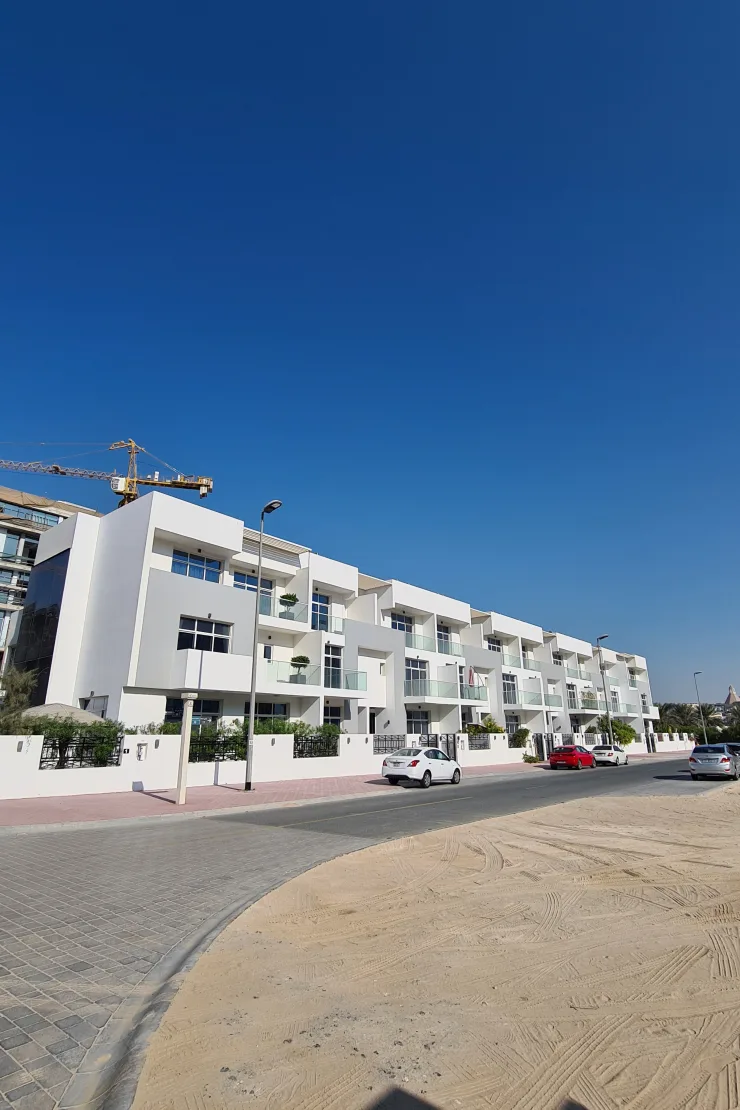 Long white townhouse row along street