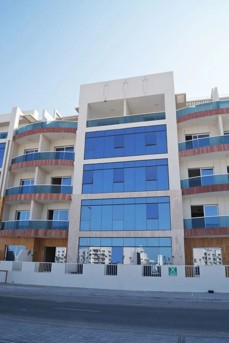 Central block with blue glazing and red-banded balconies