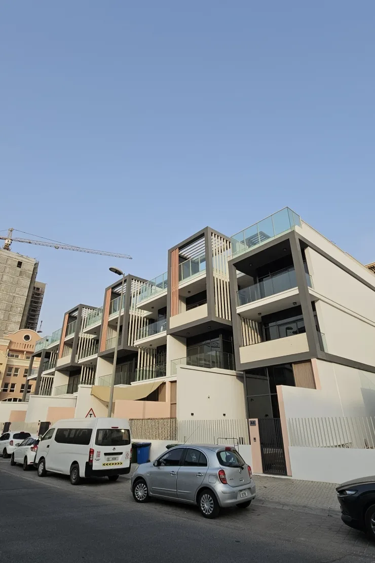 Street view of terraced facade with orange accents